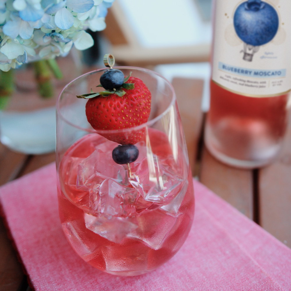 Blueberry Moscato over ice with fruit garnishes