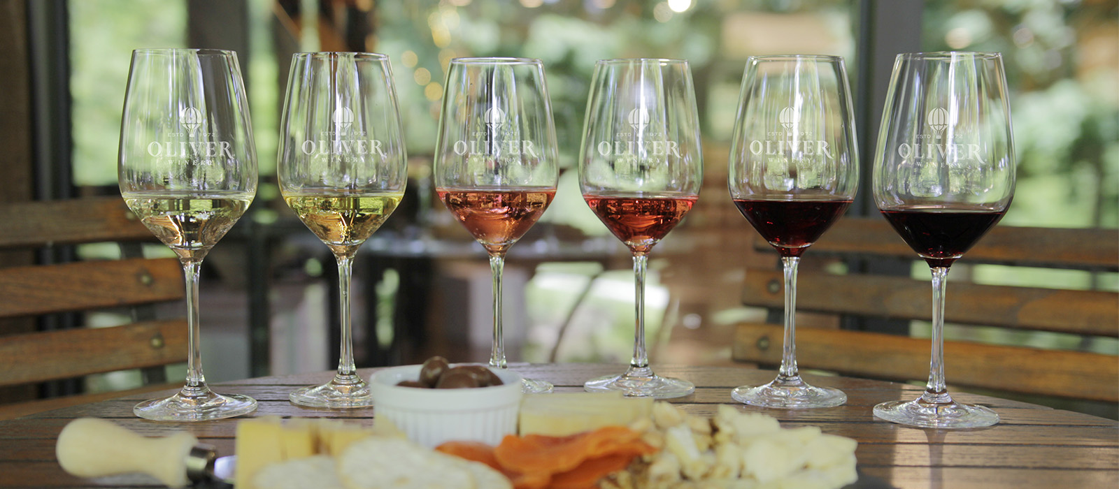 Wine glasses arranged for a reserved flight on the Oliver Winery patio 