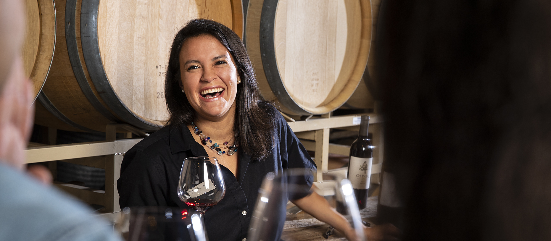 Tasting Room associate helping guests at Oliver Winery.